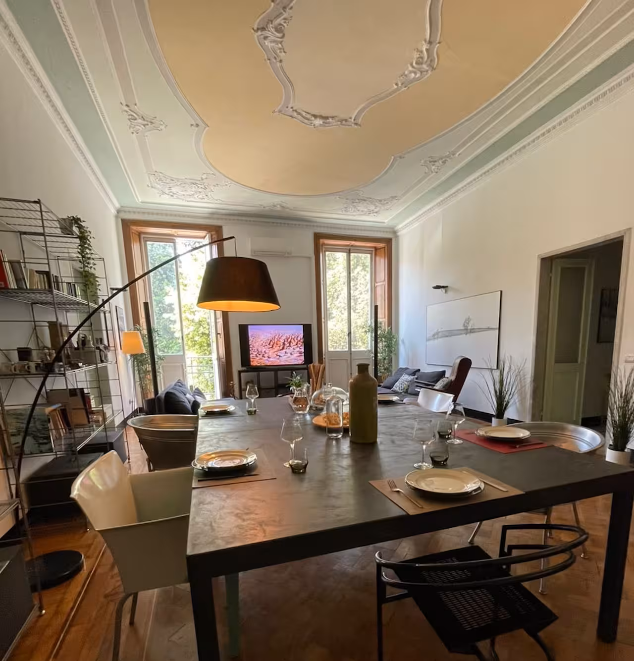 Elegant dining area in Ligurian home with stylish decor and large windows, perfect for cooking class ambiance.