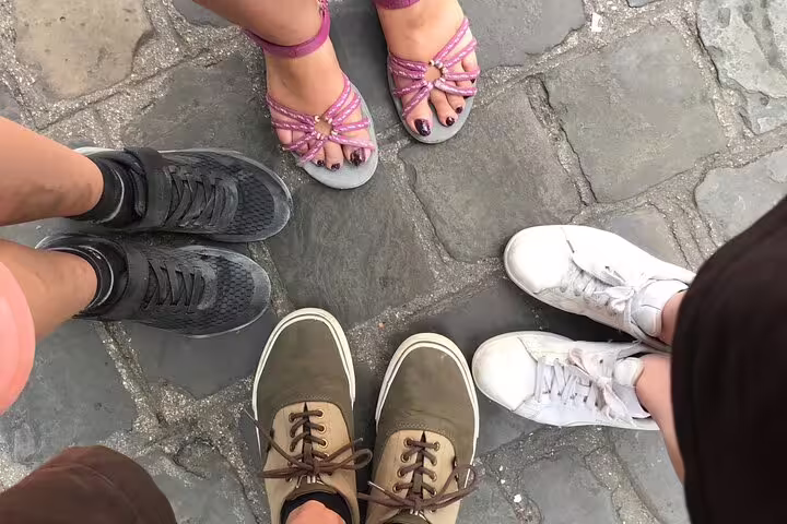 Friends’ shoes on Lille cobblestones, ready to start a scavenger hunt and city highlights walking tour adventure