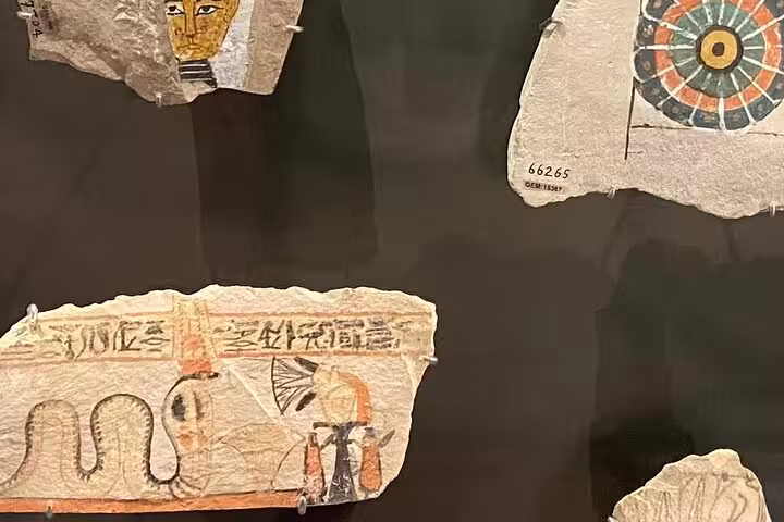 Painted limestone fragments with hieroglyphs at Grand Egyptian Museum on Giza Pyramids day tour with lunch