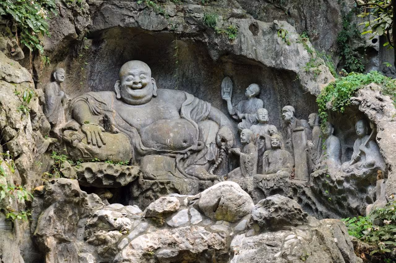 Intricate stone carvings of laughing Buddha at Lingyin Temple showcase Hangzhou's rich cultural history.