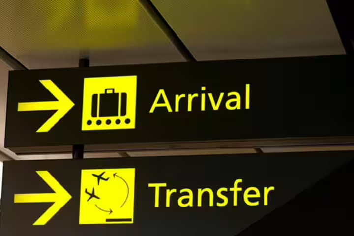 Airport signs for arrivals and transfers in Lisbon, Portugal, guiding travelers to destinations like Tomar, Leiria, Évora, Sines.