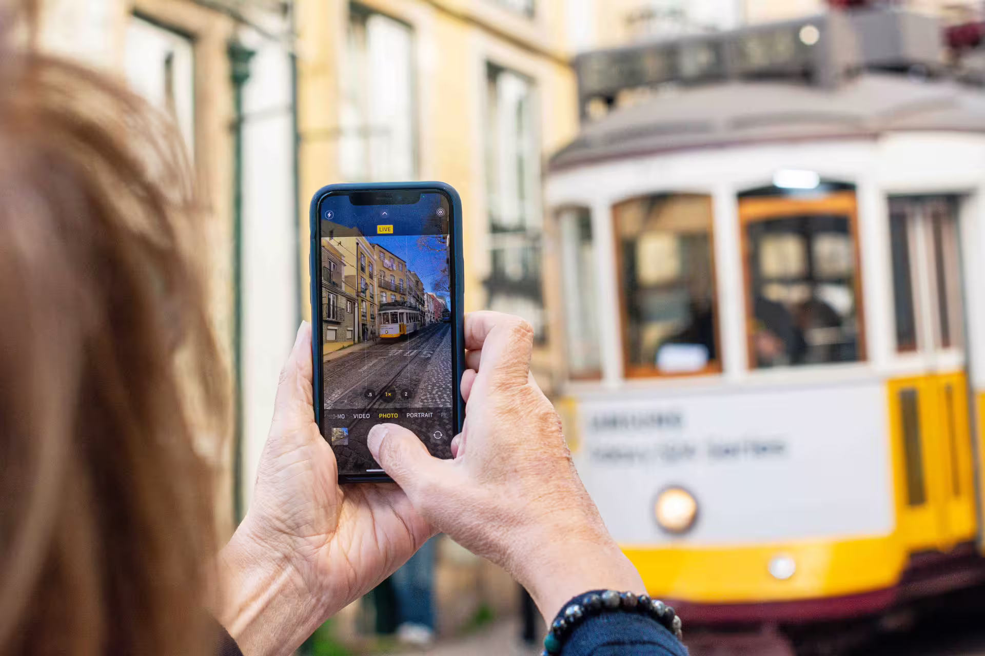 Capturing Lisbon's iconic tram in Alfama during a guided photo walk, highlighting local culture and vibrant streets.