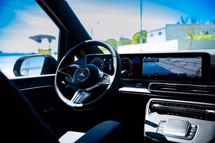 Modern Mercedes dashboard with GPS, showcasing advanced features for Lisbon to Algarve private transfer service.