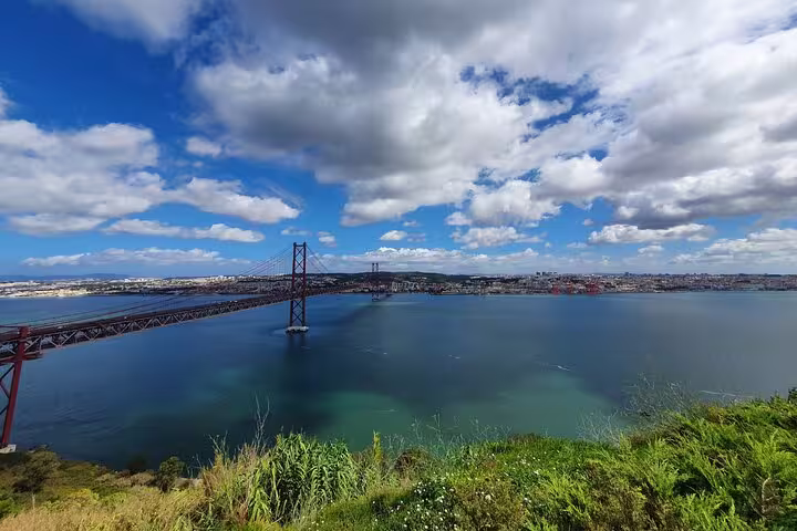 Stunning view of the 25th of April Bridge spanning the Tagus River, featured on the Lisbon to Arrábida tour.