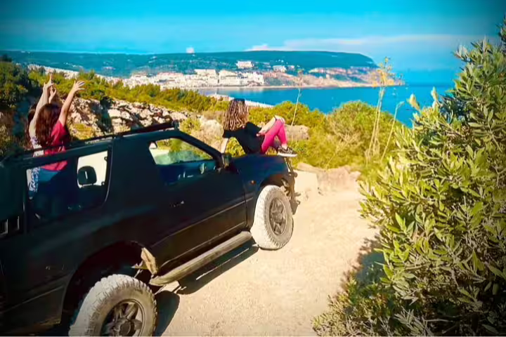 4x4 Jeep adventure in Arrábida, Sesimbra-Lisbon, overlooking stunning coastal views, perfect for a beach picnic tour.