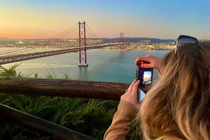 Traveler captures stunning sunset view of Lisbon's iconic bridge during a Private Full Day Setúbal & Arrábida Wine Tour.