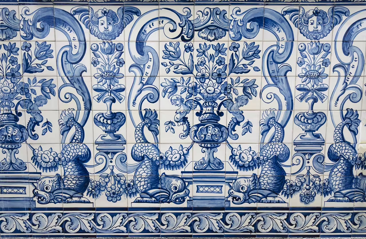 Intricate blue and white azulejos tilework depicting floral and mythical motifs in Lisbon, ideal for cultural city break.