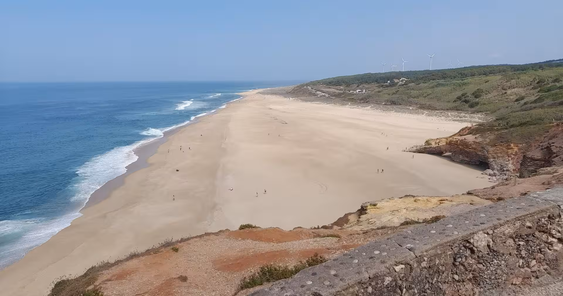 Panoramic Atlantic coastline with wide sandy beach near Lisbon, scenic stop on 7-day Portugal tour to Porto