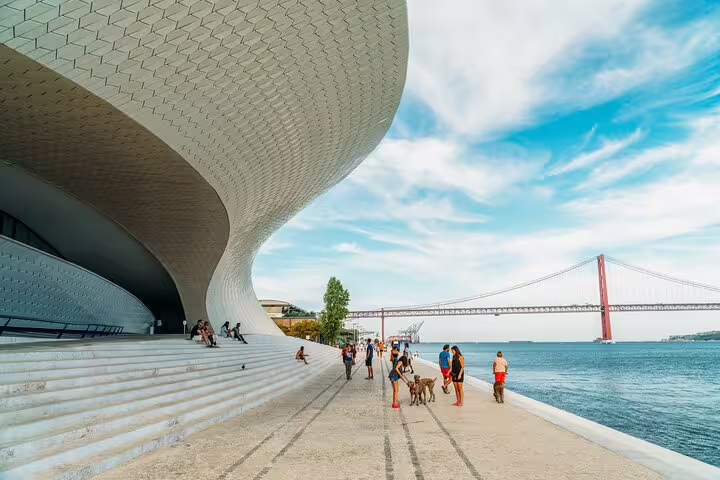 Modern architecture and scenic views of the Tagus River and bridge on the Lisbon and Belem private bike tour route.