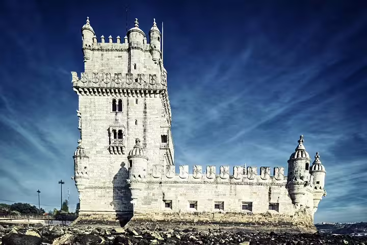 Discover the iconic Belém Tower under a vibrant sky on a premium Lisbon half-day private tour with custom stops.