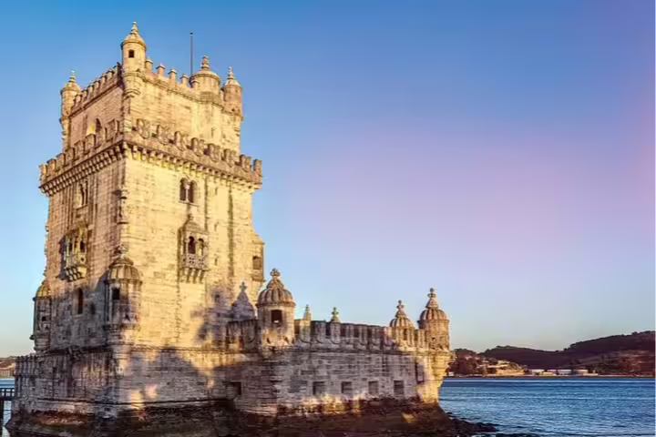 Discover Lisbon's iconic Belém Tower at sunset on a private city tour, offering stunning views and rich historical insights.