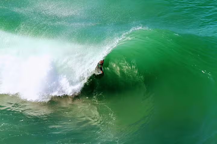 Bodyboarder riding a thrilling wave in Lisbon, showcasing the exciting adventure and vibrant ocean experience in Portugal.
