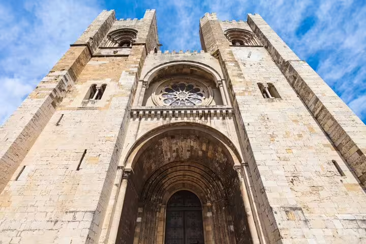 Lisbon Cathedral facade with twin towers and rose window in Alfama district