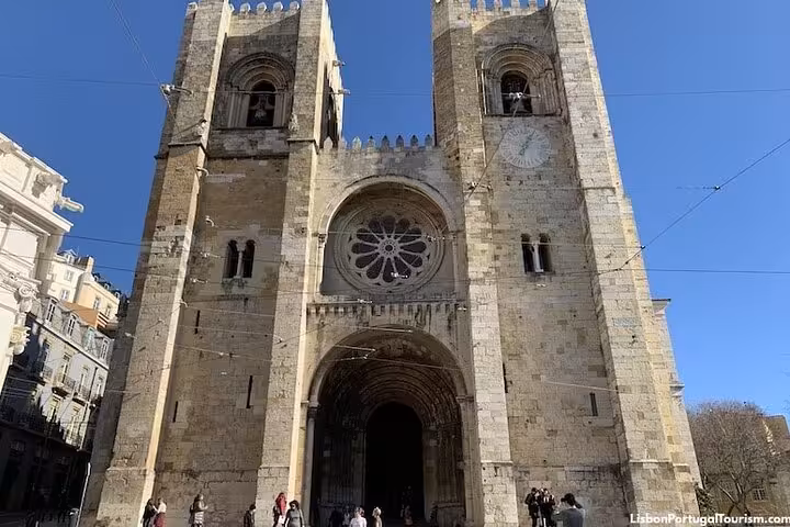 Front view of Lisbon Cathedral with clear blue skies, a highlight of the half-day private Lisbon tour.