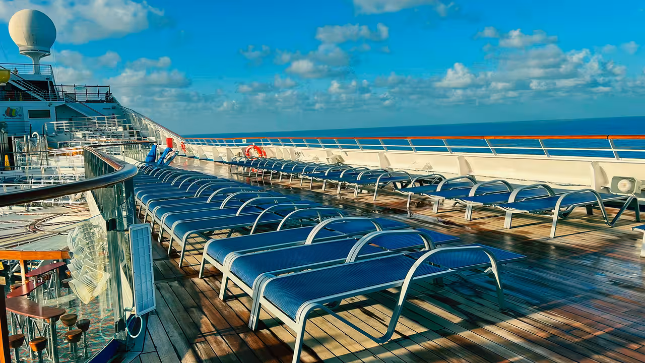 Cruise ship deck with rows of sun loungers under clear blue sky at Lisbon Cruise Terminal.