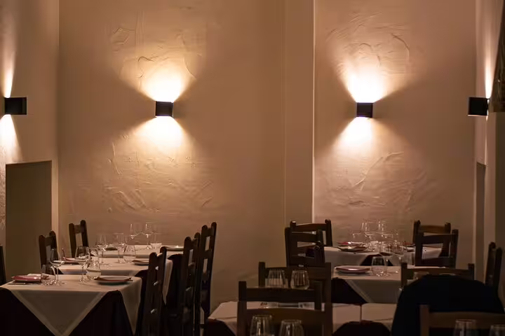 Cozy Lisbon restaurant interior with dim lighting, perfect for a Fado dinner show experience.