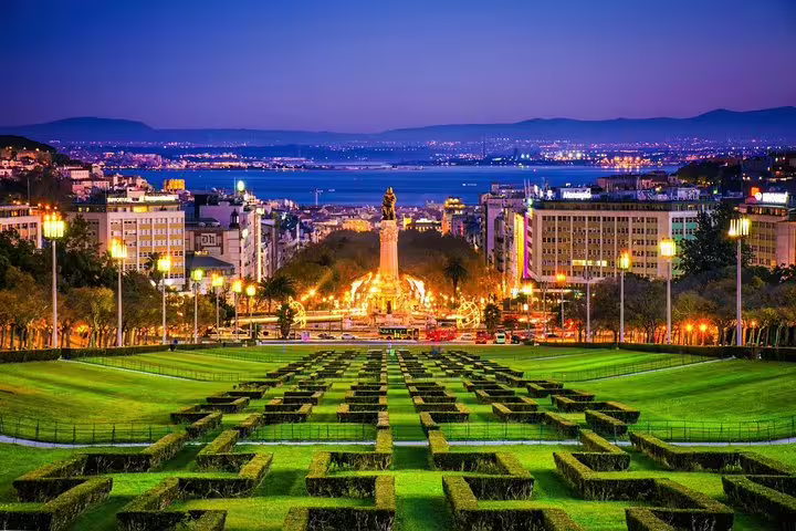Stunning nighttime view of Lisbon's illuminated streets and Eduardo VII park, ideal for a private Fado night tour experience.