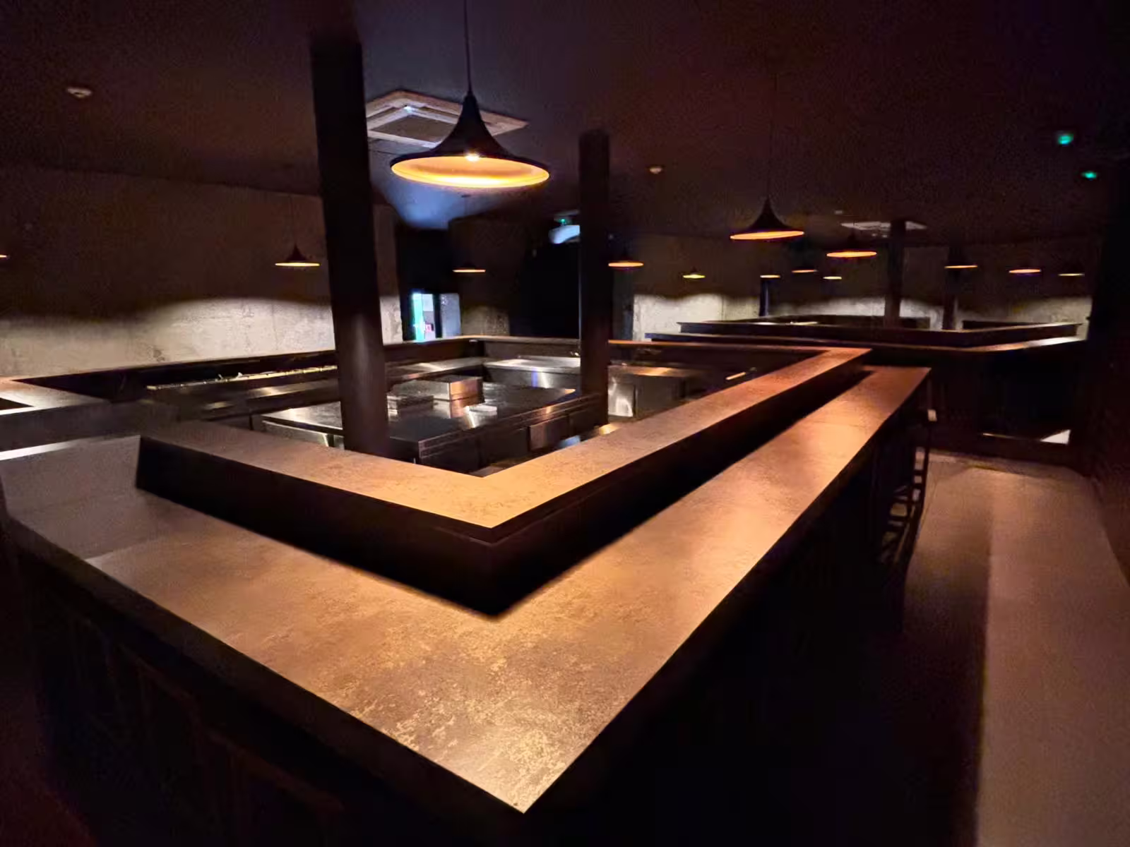 Elegant intimate setting with ambient lighting, ideal for enjoying a live Fado performance in a relaxed atmosphere.
