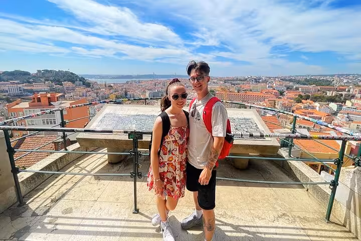 Couple at Lisbon viewpoint terrace during a 3-hour private tuk tuk tour of Lisbon historic center