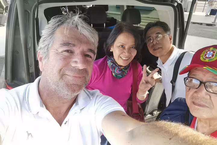 Group of travelers enjoying a private transfer from Lisbon to Madrid with scenic stops in Evora and Toledo.
