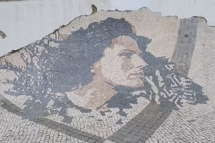 Intricate mosaic art on Lisbon street, highlighting local culture on a historical private walking tour.