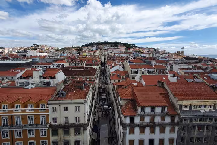 Aerial view of Lisbon's Old Town with red-tiled rooftops and historic architecture, perfect for a half-day tour exploration.