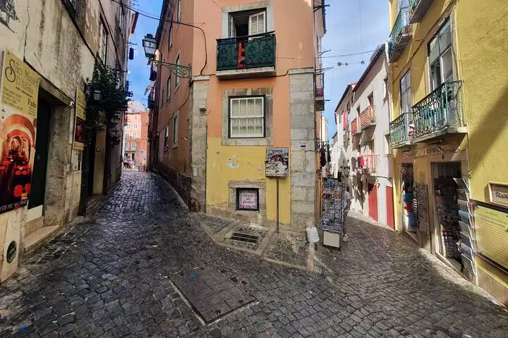 Charming narrow cobblestone streets of Lisbon's Old Town, showcasing colorful historic buildings and vibrant local life.