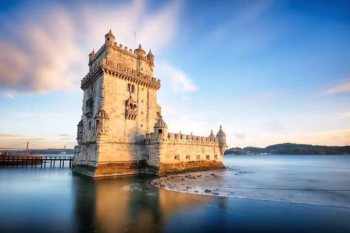 Sunset at Belém Tower in Lisbon, a historic landmark along the Lisbon to Porto private Mercedes transfer route.