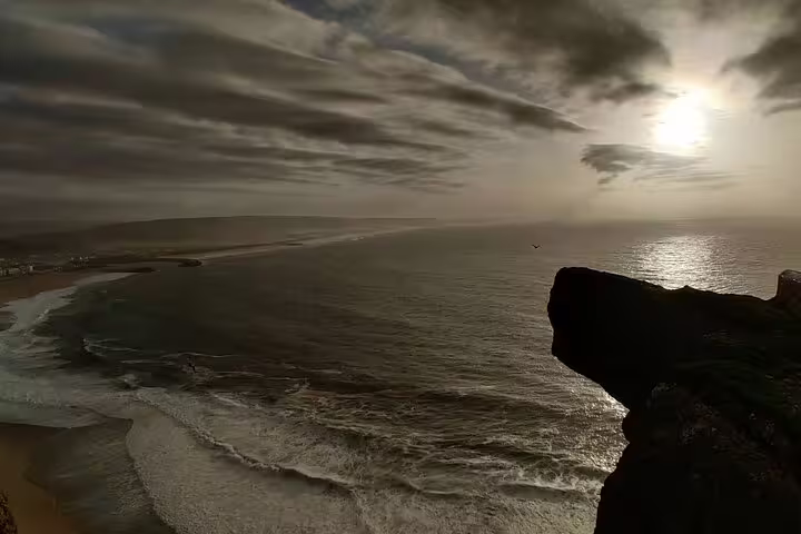 Dramatic coastal view at sunset along the scenic route from Lisbon to Porto, highlighting the beauty of Portugal's coastline.