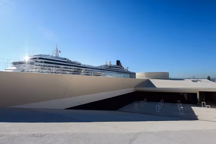 Luxury cruise ship docked in Lisbon, highlighting the scenic route for private transfers to Porto.