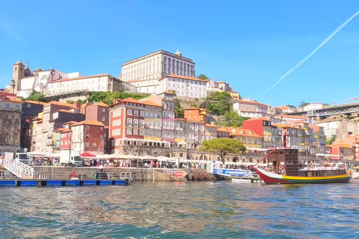 Vibrant Ribeira district in Porto seen from the river, a must-see stop on private transfer from Lisbon to Porto.