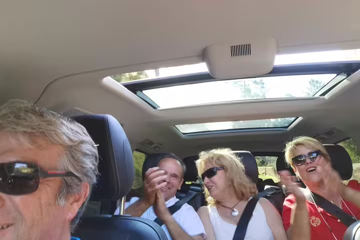Group of travelers enjoying a scenic road trip from Lisbon to Porto with stops in Obidos, Nazare, and Alcobaca.
