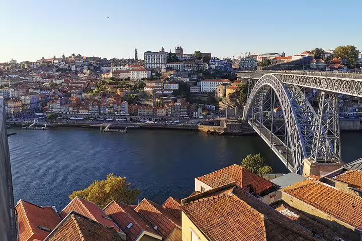 Scenic view of Porto's historic Ribeira district and Dom Luís I Bridge, a highlight on the Lisbon to Porto transfer tour.