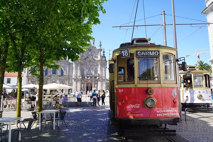 Vintage tram in a picturesque Lisbon square, highlighting scenic stops on the Lisbon to Porto transfer via Obidos, Nazare, Alcobaca.