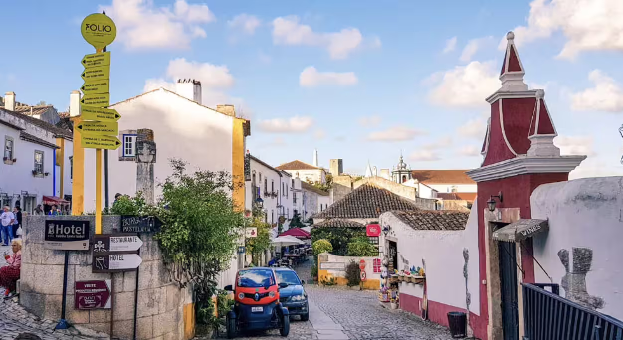 Discover charming architecture and cobblestone streets in a picturesque village on the Lisbon to Porto tour.