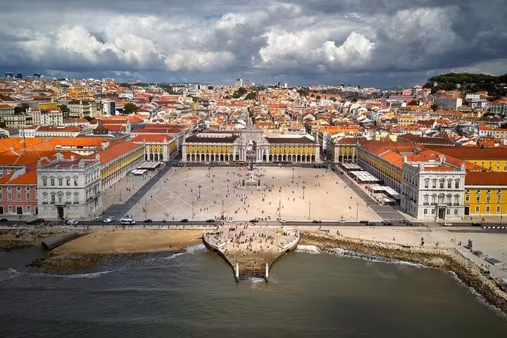 Aerial view of Lisbon's Praça do Comércio showcasing vibrant architecture and waterfront on a private city tour.