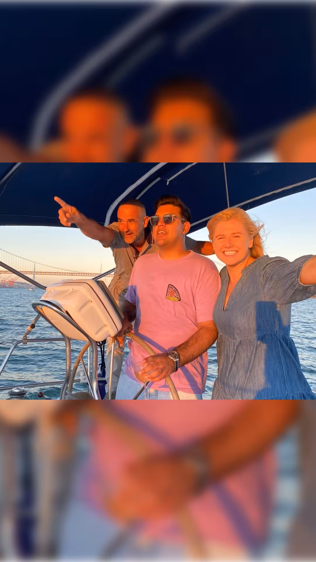 Friends enjoying a Lisbon private boat tour on the Tagus River with 25 de Abril Bridge views at sunset