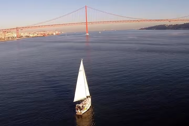 Private sailing cruise on the Tagus River under Lisbon’s 25 de Abril Bridge, drink included onboard