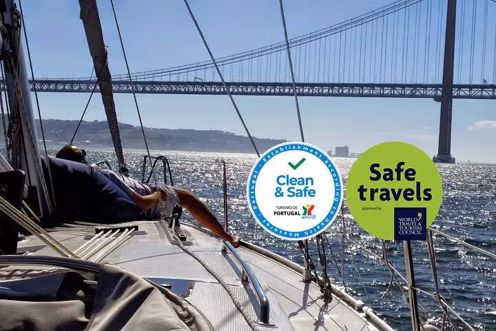 Lisbon private sailing cruise under 25 de Abril Bridge on Tagus River with Clean & Safe safe travels