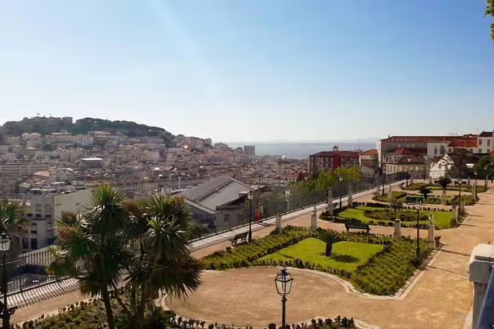 Scenic view of Lisbon's cityscape and lush gardens during a full-day private tour with custom stops in a premium vehicle.
