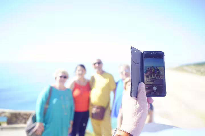 Tourists enjoying a scenic view on a full-day private tour from Lisbon to Óbidos, Nazaré, Alcobaça, Batalha, and Fátima.