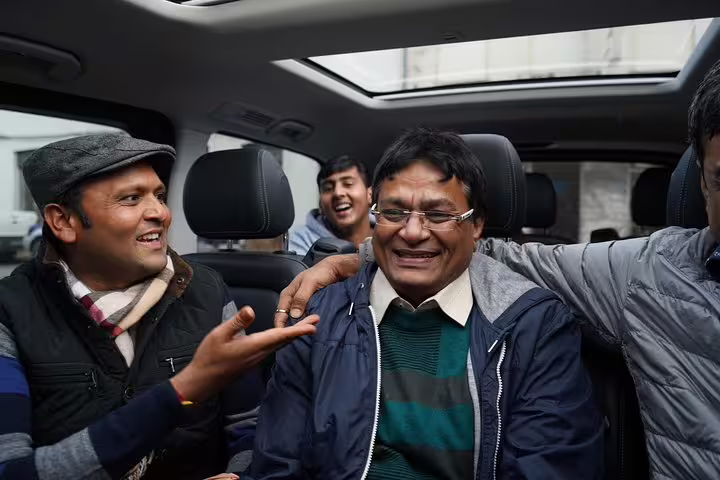 Group of happy tourists enjoying a private tour from Lisbon to Óbidos, Nazaré, Alcobaça, Batalha, and Fátima in a comfortable vehicle.