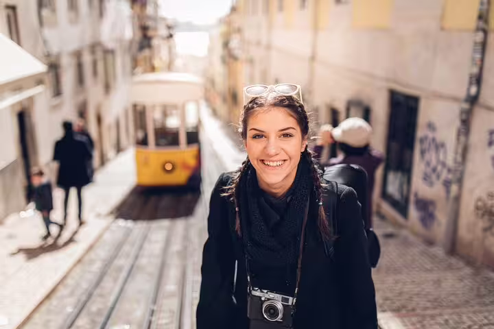 Smiling tourist explores Lisbon's charming streets with iconic yellow tram during a full-day private tour and gastro experience.
