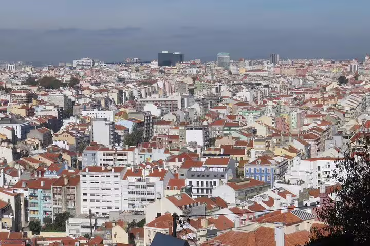 Panoramic view of Lisbon's iconic red rooftops and sprawling cityscape, perfect for a private half-day tour.