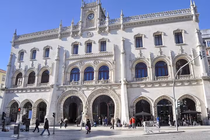 Historic Rossio train station in Lisbon with neo-Manueline architecture, showcasing intricate arches and detailed facade.