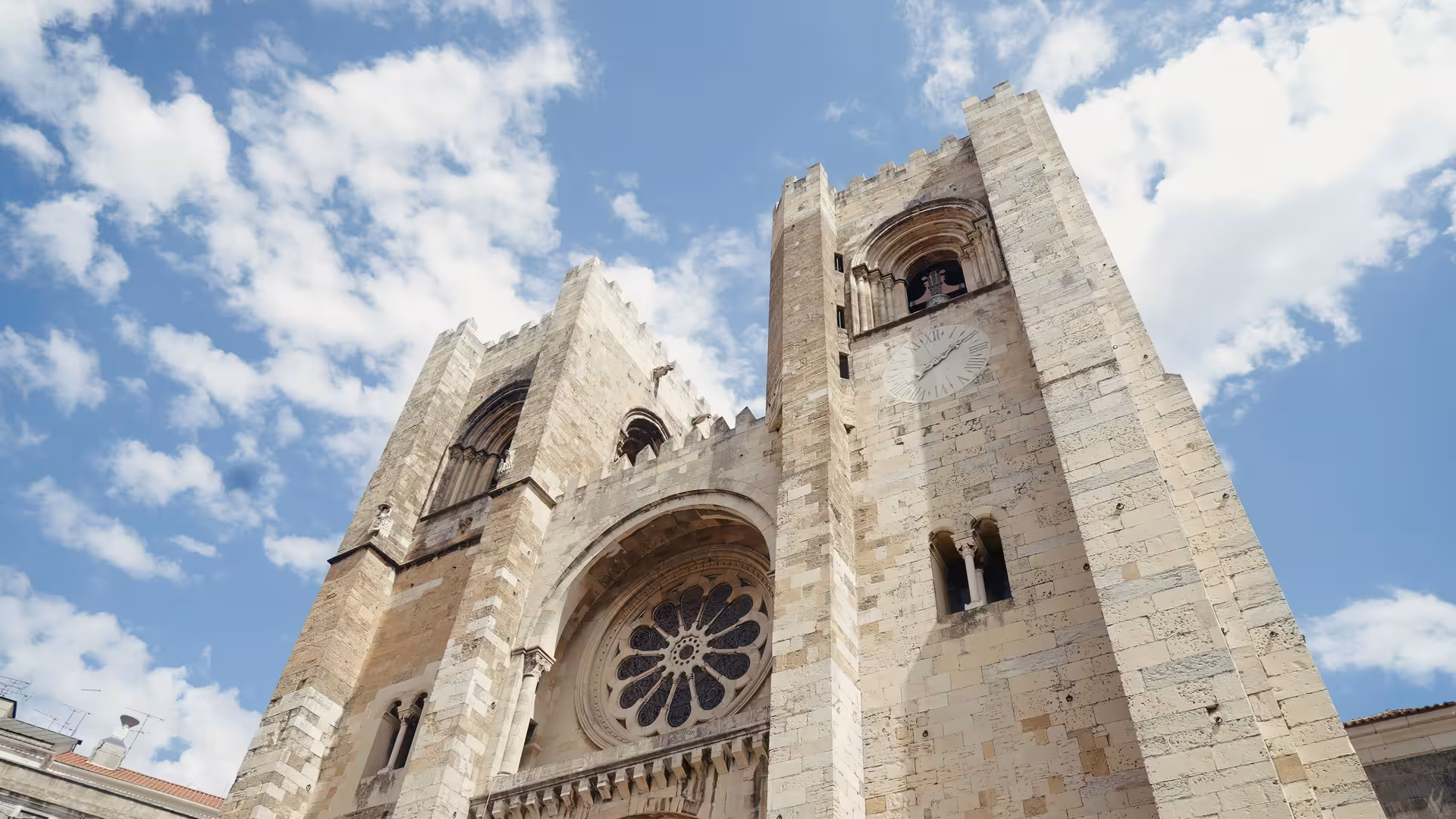 Low-angle view of Lisbon Se Cathedral twin towers a must-see landmark on the Alfama Fado and Azulejos walking tour