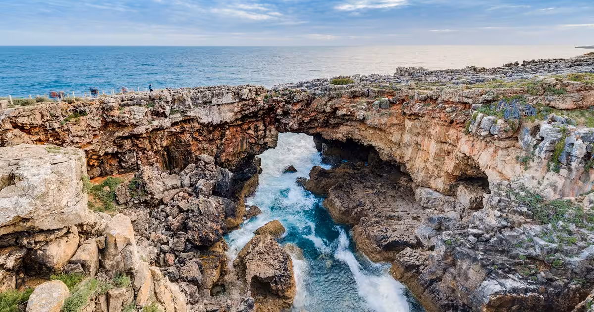 Dramatic coastal cliffs at Boca do Inferno near Cascais, with waves crashing against the rocks, highlighting Sintra tour scenery.