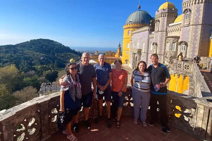 Visitors exploring the stunning vista from Pena Palace during a Lisbon to Sintra guided tour in small group.