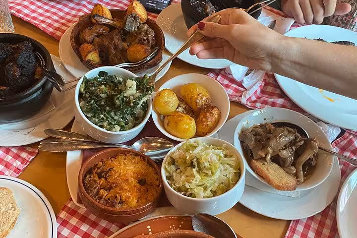Traditional Portuguese dishes served at a local restaurant, highlighting the culinary experience on the Lisbon to Sintra tour.