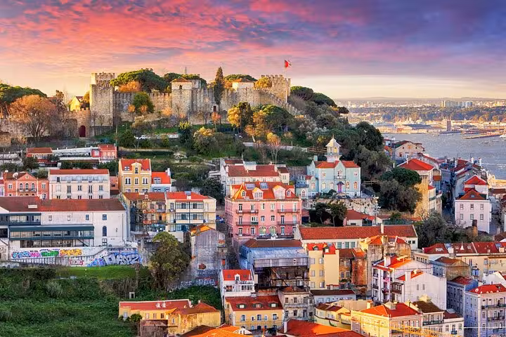 Colorful Lisbon skyline with historic São Jorge Castle perched on a hill, overlooking the Tagus River.